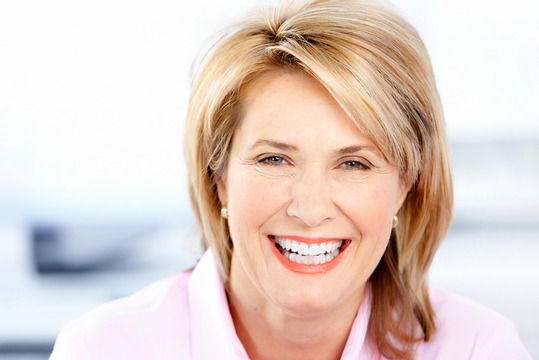 Smiling woman wearing a white shirt